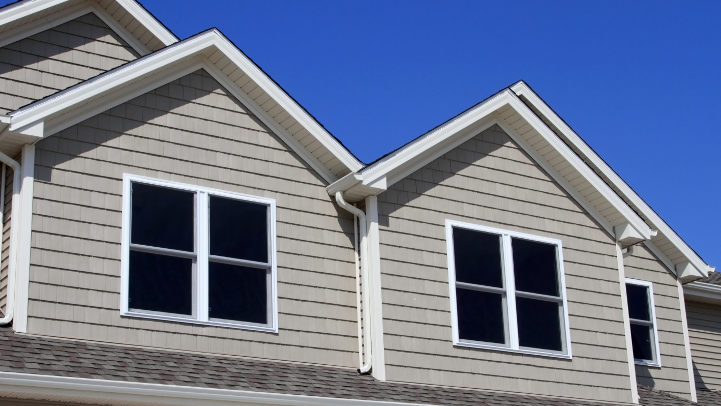 A house with three windows and a sky background
